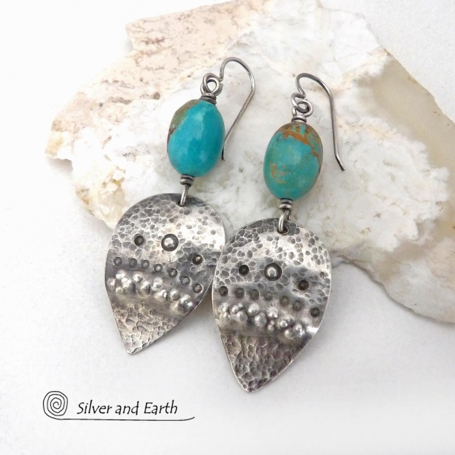 These handcrafted earrings feature natural turquoise nuggets accented with sterling silver dangles with a hammered and hand stamped texture. The stones are a gorgeous shade of turquoise with a natural copper matrix. They have an earthy organic, modern style with southwestern flair. The earrings are handmade and are a beautiful example of southwest style jewelry. Handmade by Silver and Earth, a New Mexico True Certified business.