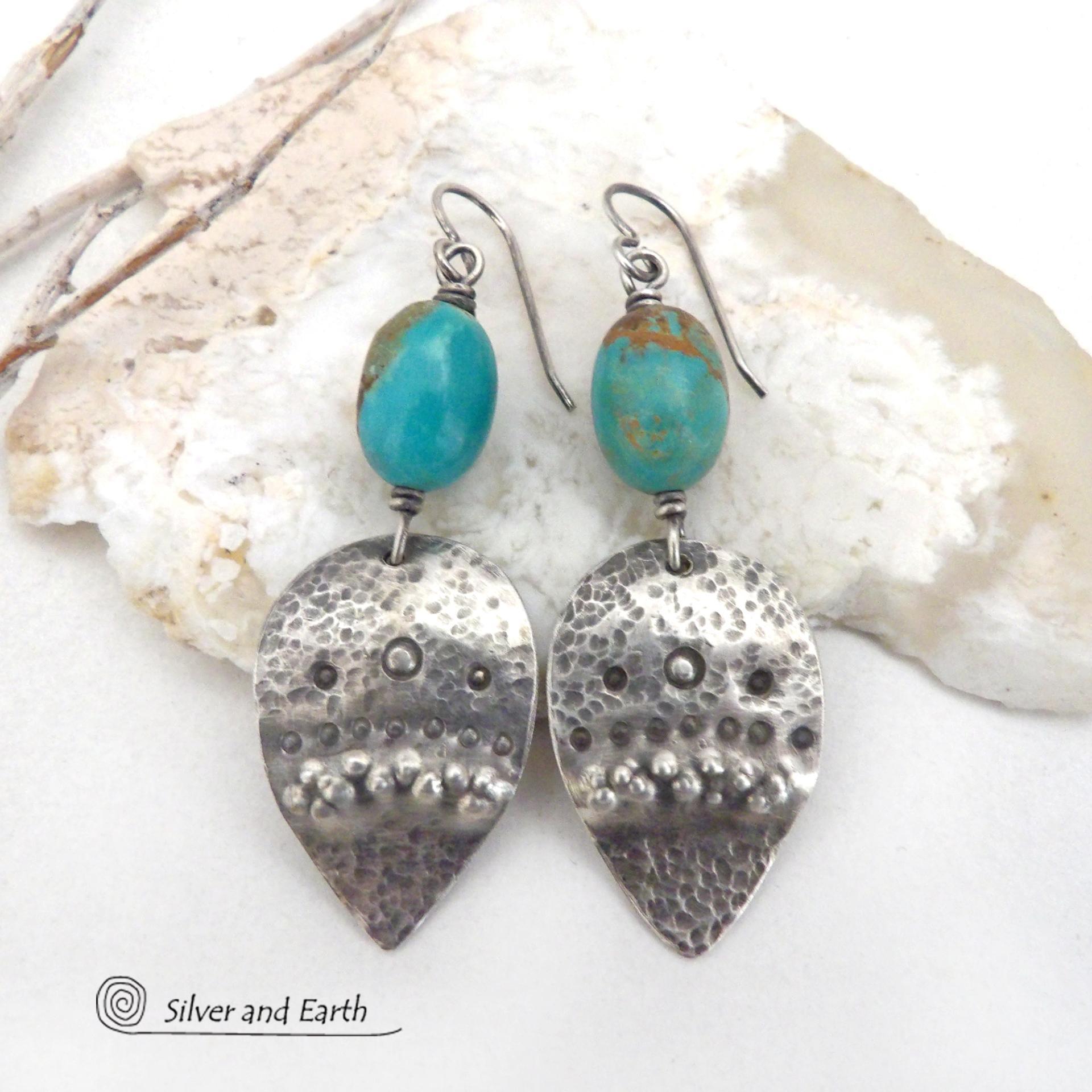 These handcrafted earrings feature natural turquoise nuggets accented with sterling silver dangles with a hammered and hand stamped texture. The stones are a gorgeous shade of turquoise with a natural copper matrix. They have an earthy organic, modern style with southwestern flair. The earrings are handmade and are a beautiful example of southwest style jewelry. Handmade by Silver and Earth, a New Mexico True Certified business.