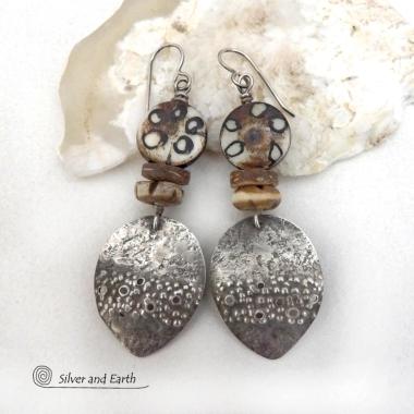 Unique and one of a kind, these handcrafted sterling silver earrings have a funky edgy vibe with ethnic tribal flair. They feature rustic hammered sterling silver dangles accented with African batik, bone and brown coconut shell beads. Bold and exotic, they'll add a touch a bohemian tribal style to your wardrobe that is sure to make a statement.