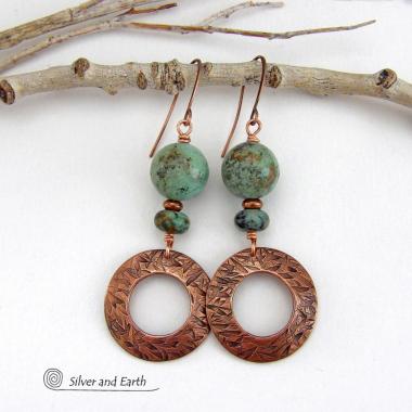  These handcrafted earrings feature round copper hoop dangles with a hand stamped texture accented with a stack of natural African turquoise stones and tiny copper beads. The stones have a pretty turquoise hue with an earthy natural black and brown matrix. These earrings have an earthy chic style with a modern bohemian flair that will coordinate beautifully with all wardrobe types. Handmade in the USA by Silver and Earth Jewelry.  Your choice of ear wires - copper or hypoallergenic niobium. 