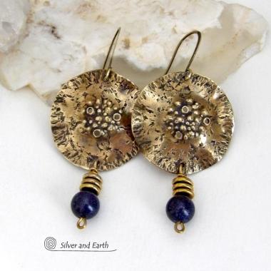 These handcrafted gold brass earrings have a rustic, hammered texture and are accented with dangling dark blue goldstones and small brass beads. They have a modern chic style with an earthy, organic vibe. Goldstone is a man-made stone of quartz sand glass infused with copper particles which creates the subtle sparkle effects. It was invented in Venice, Italy in the seventeenth century. These earrings are perfect for women that love unique, bold one-of-a-kind artisan handmade jewelry. 