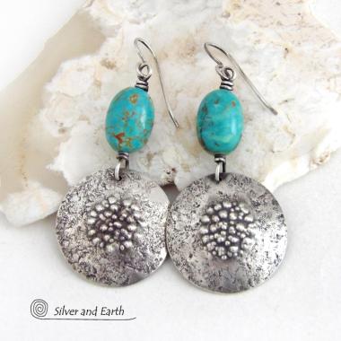 These handcrafted earrings feature natural turquoise nuggets accented with round sterling silver dangles with a rustic hammered and stamped texture. The stones are a gorgeous shade of turquoise with a subtle natural copper matrix. They have a modern, earthy organic style with a touch of southwestern flair.