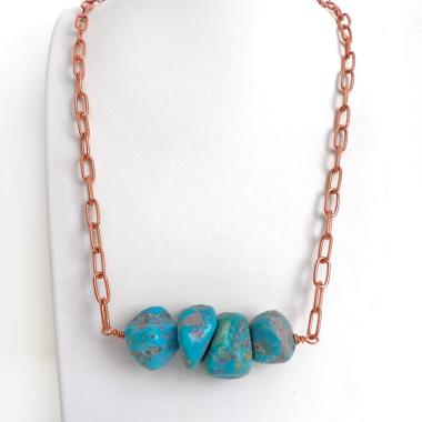 This chunky turquoise necklace features big, organically-shaped nuggets of genuine natural turquoise accented with a copper link chain. The turquoise is a stunning shade of blue - reminiscent of the lovely blue skies here in the American Southwest. Unique and one-of-a-kind, it will make a bold statement. Perfect for women that love bold unique jewelry made with natural stones. Handmade in the USA by Silver and Earth Jewelry. 