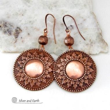 These handcrafted copper earrings have a beautifully detailed embossed sun medallion texture with an oxidized finish and are accented with brushed satin copper beads. Big and bold, they'll make a striking statement. Unique and versatile, they are lightweight and comfortable to wear and will look great with all wardrobe styles. Handmade in the USA by Silver and Earth Jewelry.