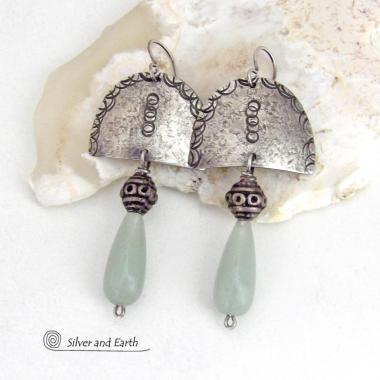 These unique sterling silver earrings have a funky bohemian tribal flair. They feature handcrafted sterling silver shapes with a hand textured design accented with natural green aventurine gemstones and vintage silver beads.