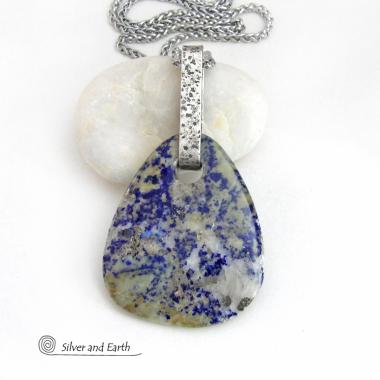 This one-of-a-kind necklace features a stunning natural gemstone comprised of natural lapis lazuli inclusions embedded in a calcite base. Lapis lazuli is formed with three minerals in varying amounts: lazurite, calcite, and pyrite. This stone has a unique matrix pattern with a blend of lapis with calcite which has a soft yellowish hue and a sprinkling of shimmery pyrite inclusions. Each side has it's own unique beauty, so I designed it to be reversible.