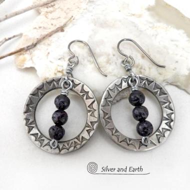 These handcrafted silver pewter hoop earrings have a hand stamped texture accented with black lava rock stones dangling in front. The stones have natural "pits" and crevices which is expected with porous lava stones. Lava stone is formed when molten rock erupts from an active volcano and comes in contact with the cool atmosphere of the Earth, which begins to solidify it. They have an earthy chic style that coordinates with all wardrobe types.