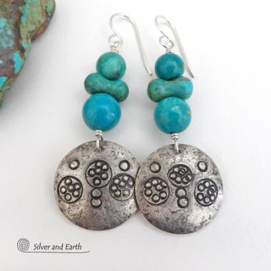 These handcrafted earrings feature sterling silver dangles with a hand stamped texture accented with a stack of round and uniquely "bow shaped" genuine natural turquoise stones. Bold and striking, they have an earthy modern rustic vibe with southwest style and flair that will look great with all types of outfits. Handmade in the USA, Silver and Earth is a small business that is New Mexico True Certified. She is known for her known for her unique one-of-a-kind and limited edition designs. 