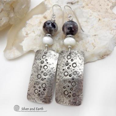 These handcrafted sterling silver earrings have a hand stamped and lightly hammered organic texture and are accented with natural sunstone / moonstone gemstones and mother of pearl and small stainless steel beads. This hybrid stone is rare and found only in Tanzania. It has beautiful shimmery hues of black with natural silvery flashes and subtle peach and gold inclusions. These earrings have a modern, elegant chic style that looks great dressed up or down. Perfect for women that love unique gemstone jewelry
